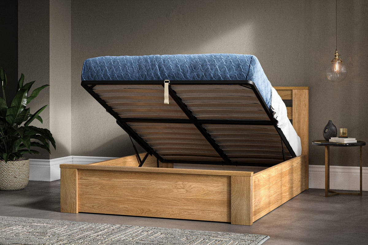 Oak ottoman bed with the gas lift open, showing the lift frame raised on its two mechanisms