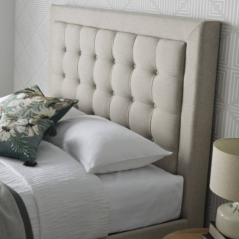 Tooting fabric ottoman bed in oatmeal, close-up of the buttoned headboard