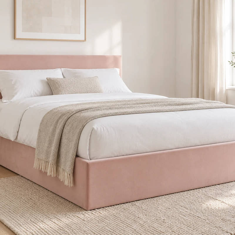 Camden blush pink velvet ottoman bed with a low headboard, shown in a bright UK bedroom