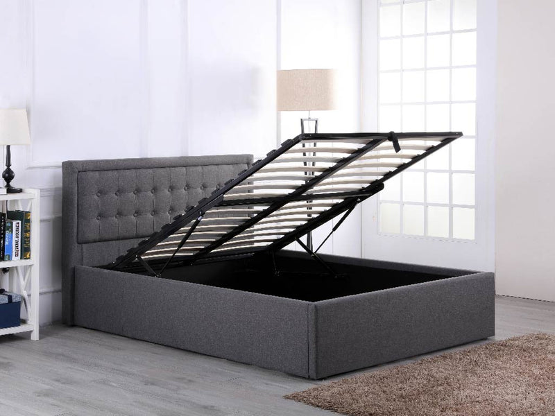 Hammersmith grey fabric ottoman bed with a buttoned headboard, with the gas lift storage open
