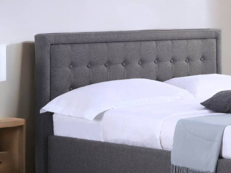 Hammersmith grey fabric ottoman bed with a buttoned headboard, close-up of the buttoned headboard