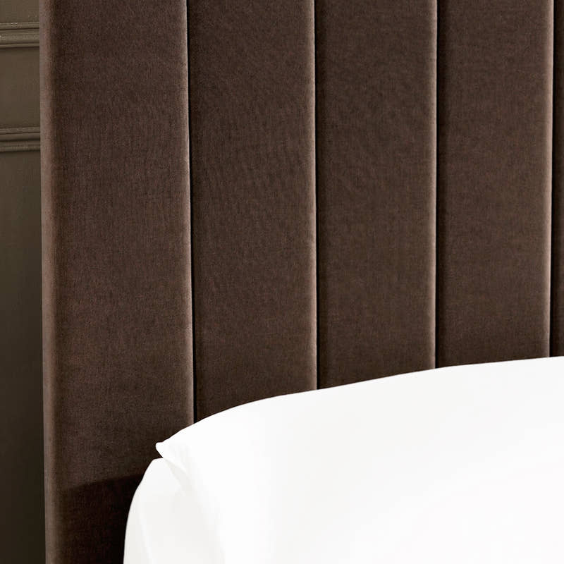 Aylen bed: chocolate velvet headboard padded in vertical channels, close up