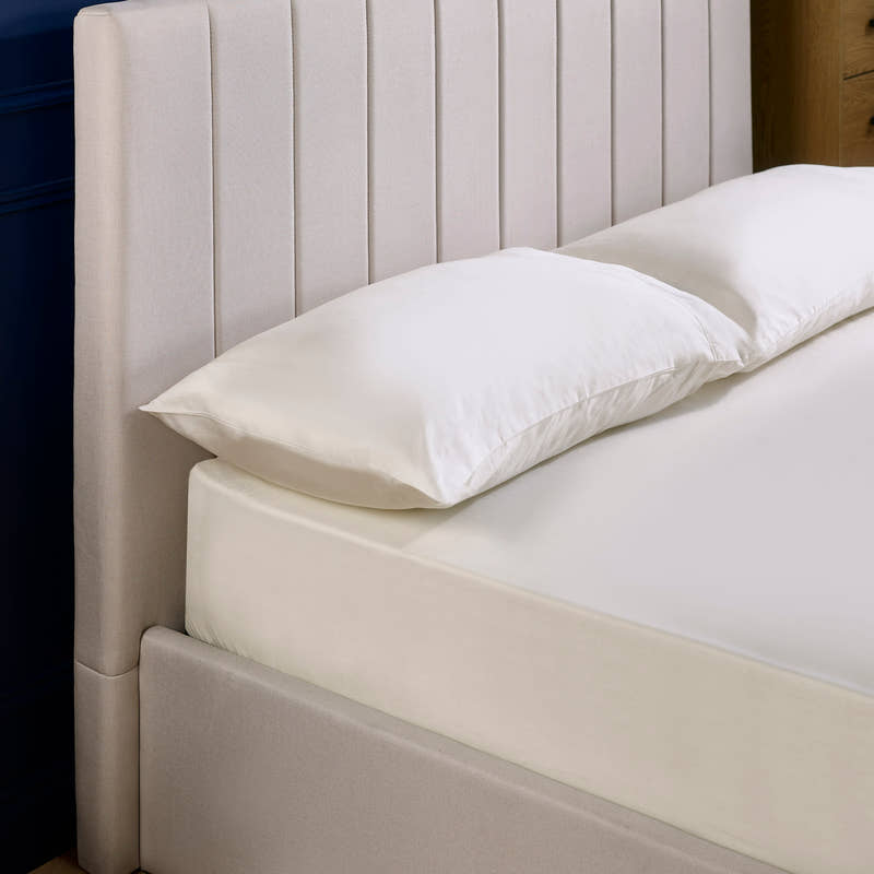 Aylen bed: oatmeal headboard padded in vertical channels, close up