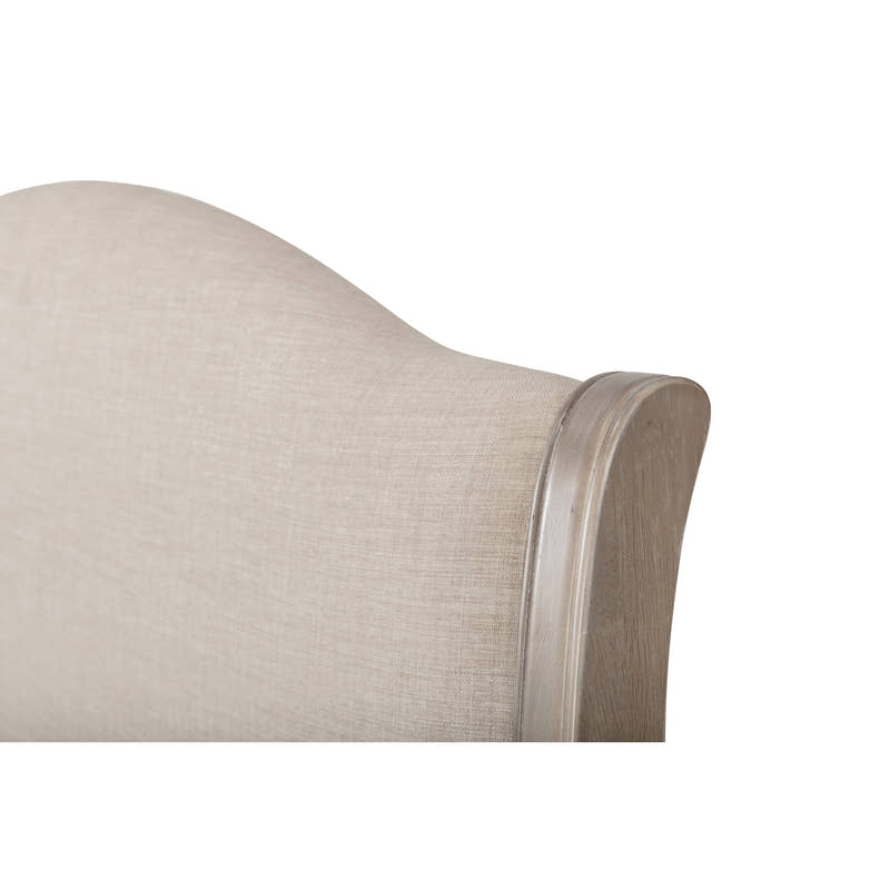 Camille bed: corner of the curved oatmeal linen headboard and its limed oak frame, close up