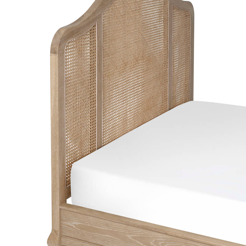 Fleur bed: the arched woven cane headboard, close up