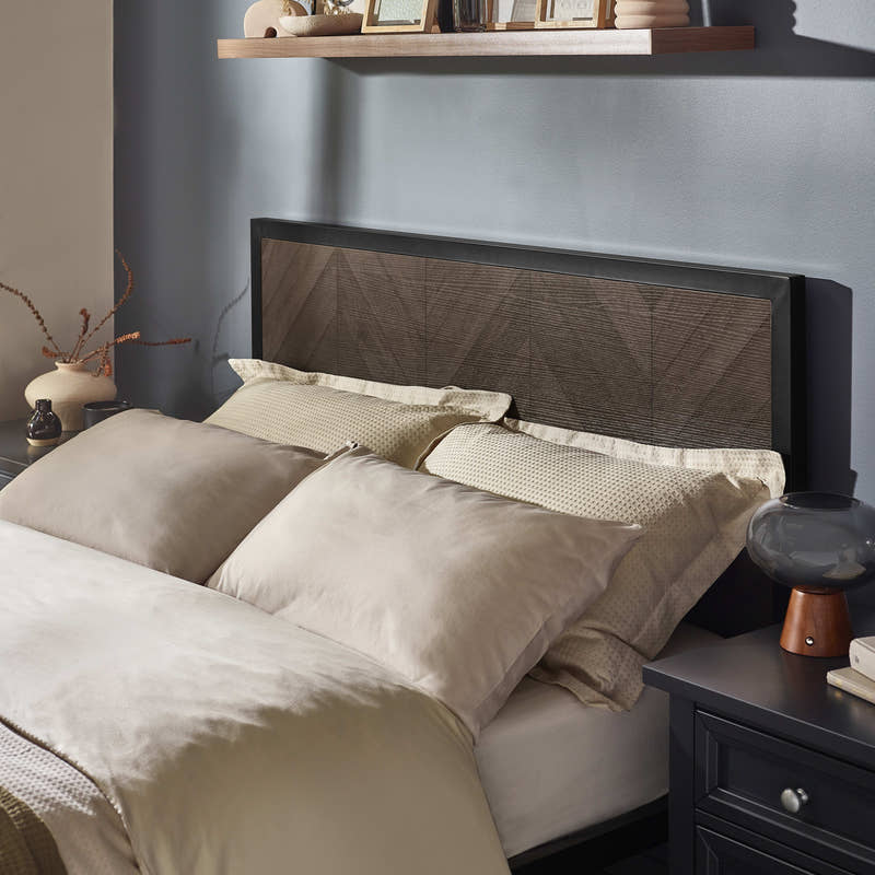 Harrison bed: dark oak herringbone effect headboard in a black frame, behind the pillows