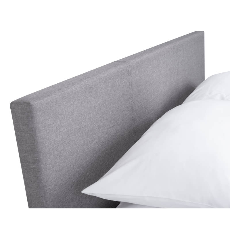 Rialto ottoman bed: the grey linen padded headboard with a pillow, close up