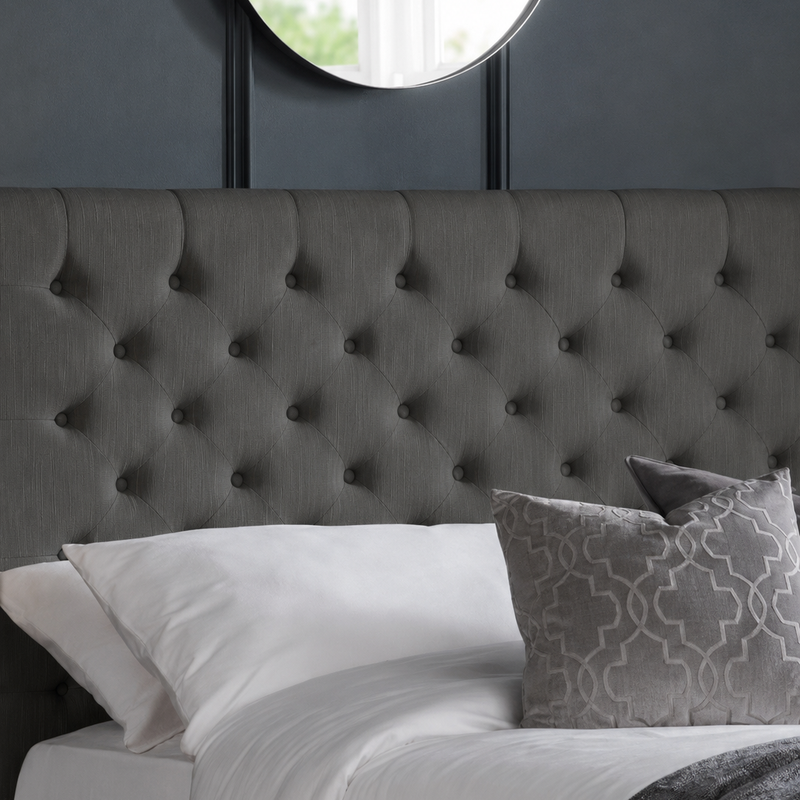 Wilton bed: the dark grey deep buttoned headboard with pillows, close up