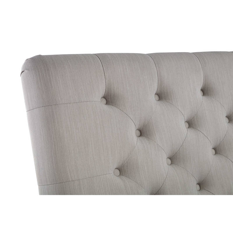 Wilton bed: the curved edge of the light grey buttoned headboard, close up