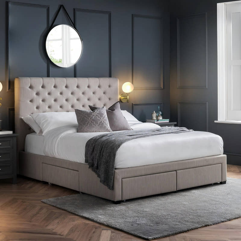 Julian Bowen Wilton light grey bed with a deep buttoned headboard and drawers closed, in a bedroom