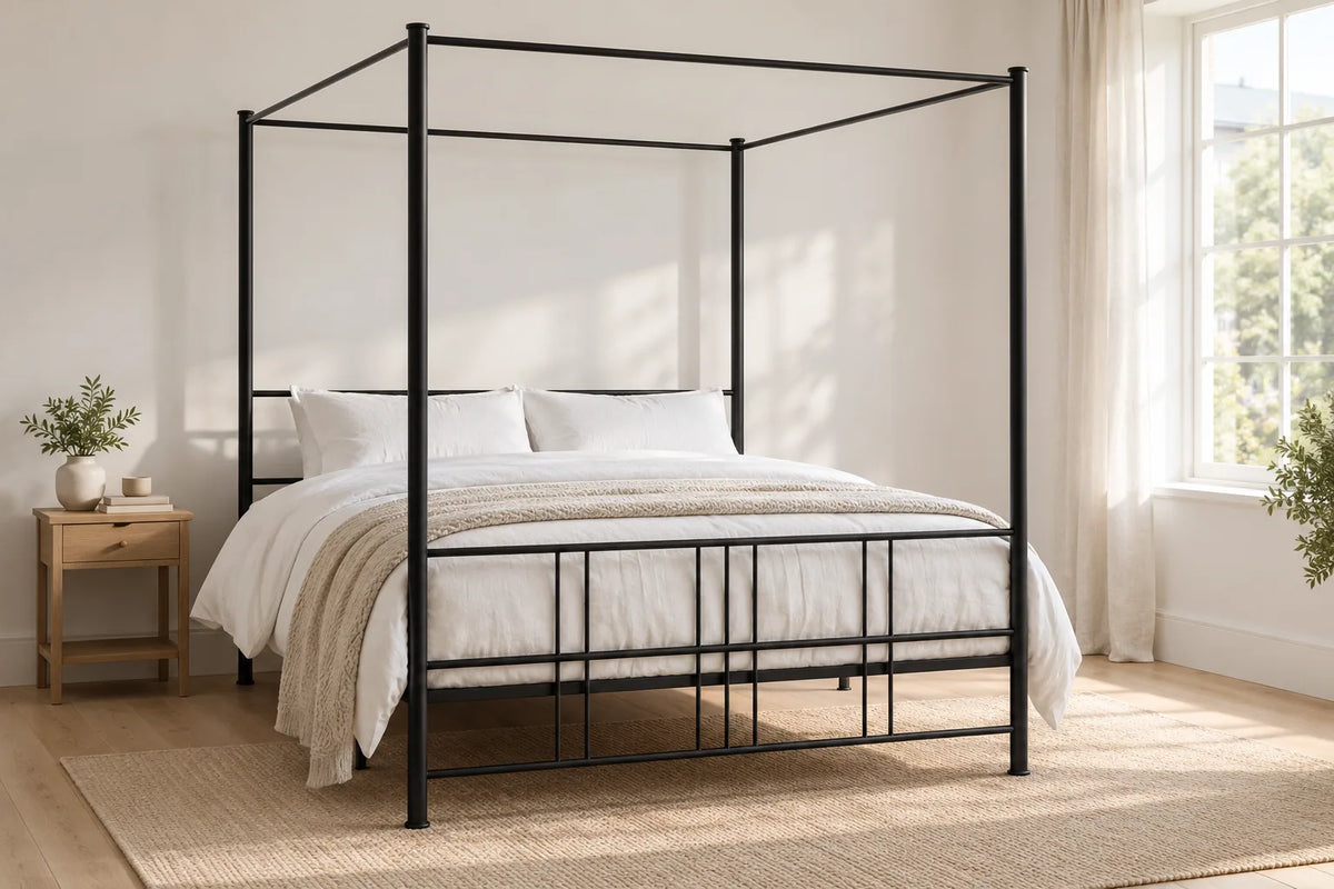 Knightsbridge black four poster iron bed, shown in a bright UK bedroom