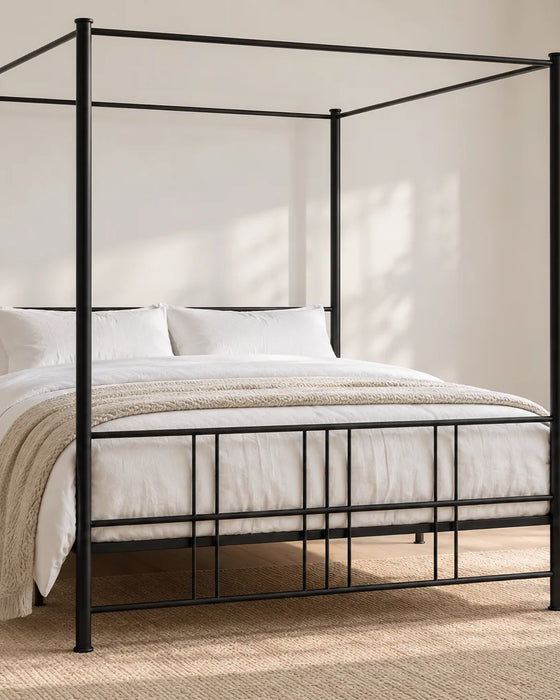 Knightsbridge black four poster iron bed, shown in a bright UK bedroom