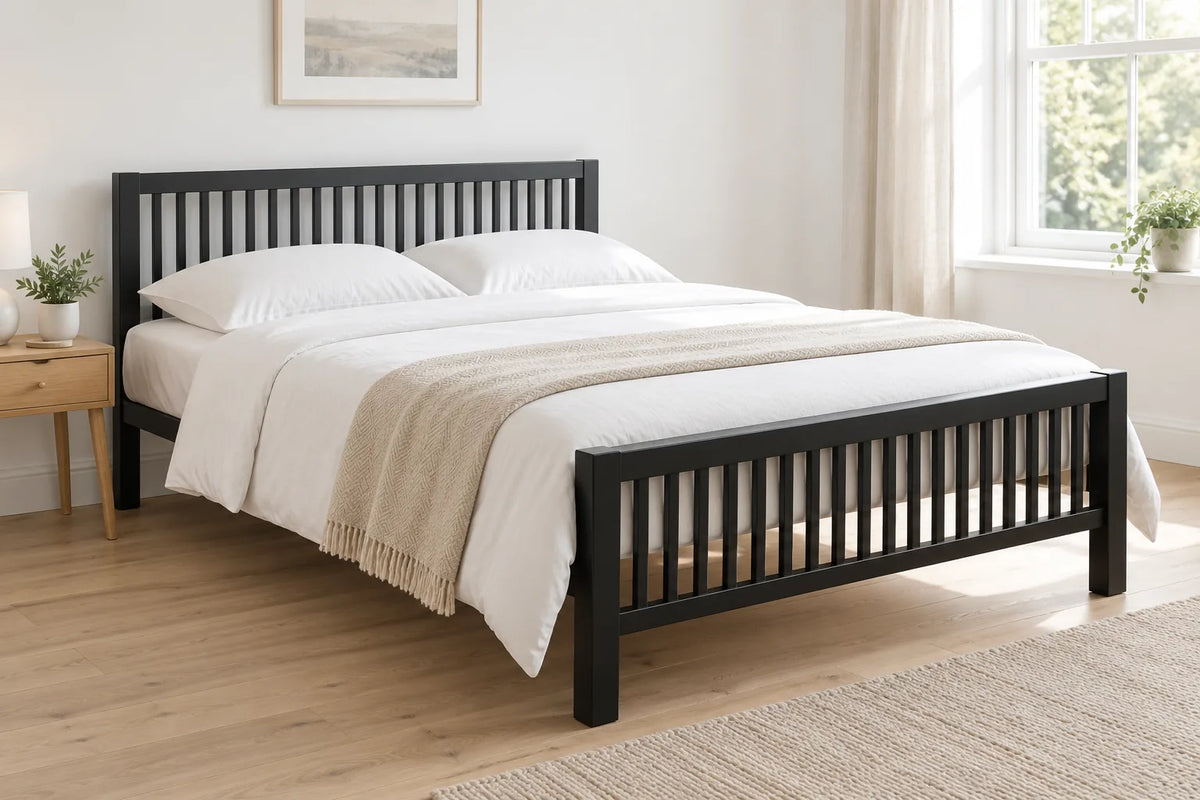 Meridian king size metal bed frame in black with a slatted headboard and footboard, in a bright UK bedroom