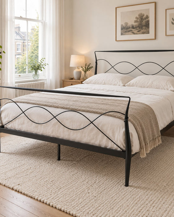 Ladbroke black metal bed frame in king size with curved posts and a wave headboard, in a bright Victorian bedroom (AI-generated illustration of this frame; bedding for illustration, mattress not included)