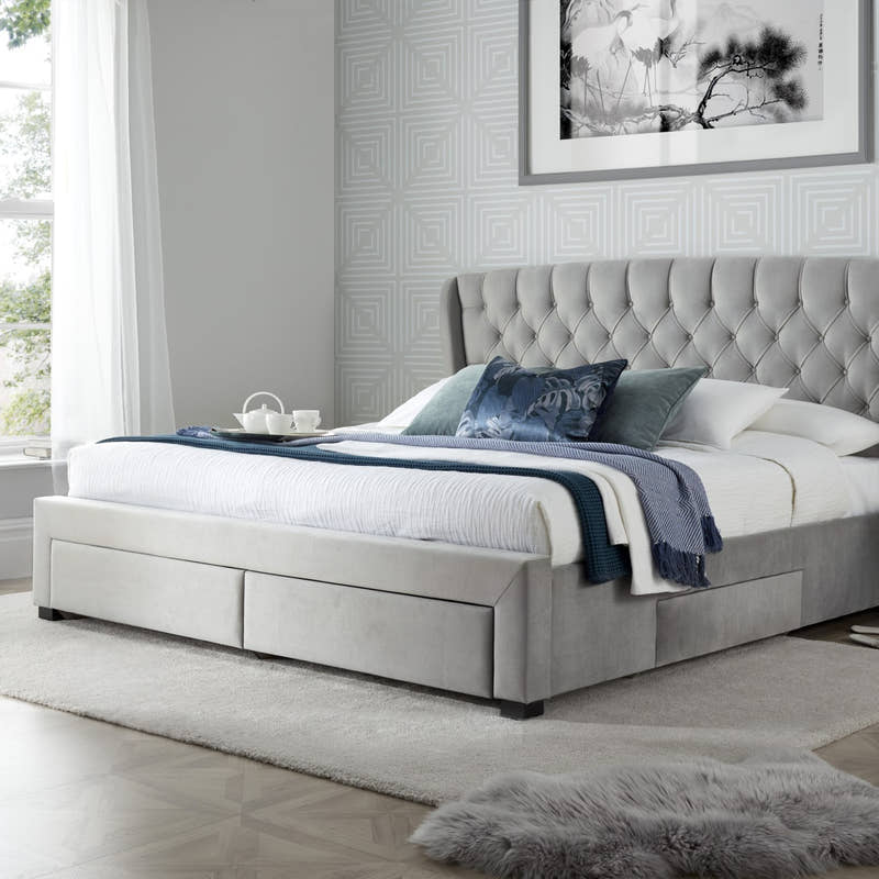 Hendon velvet storage bed in grey velvet, with the drawers closed, in a bedroom