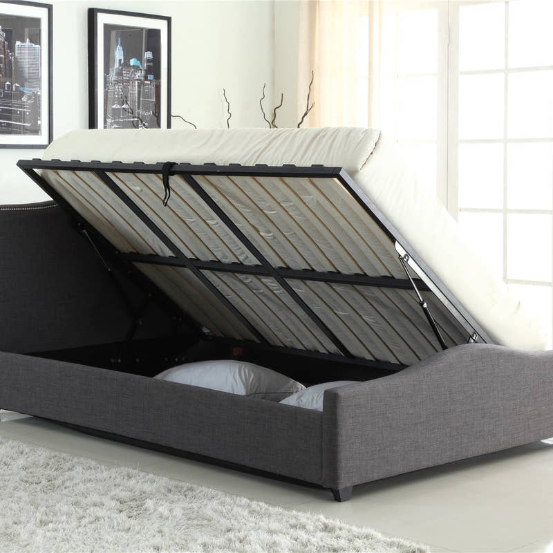 Bexley grey fabric ottoman bed with the base lifted to show the storage