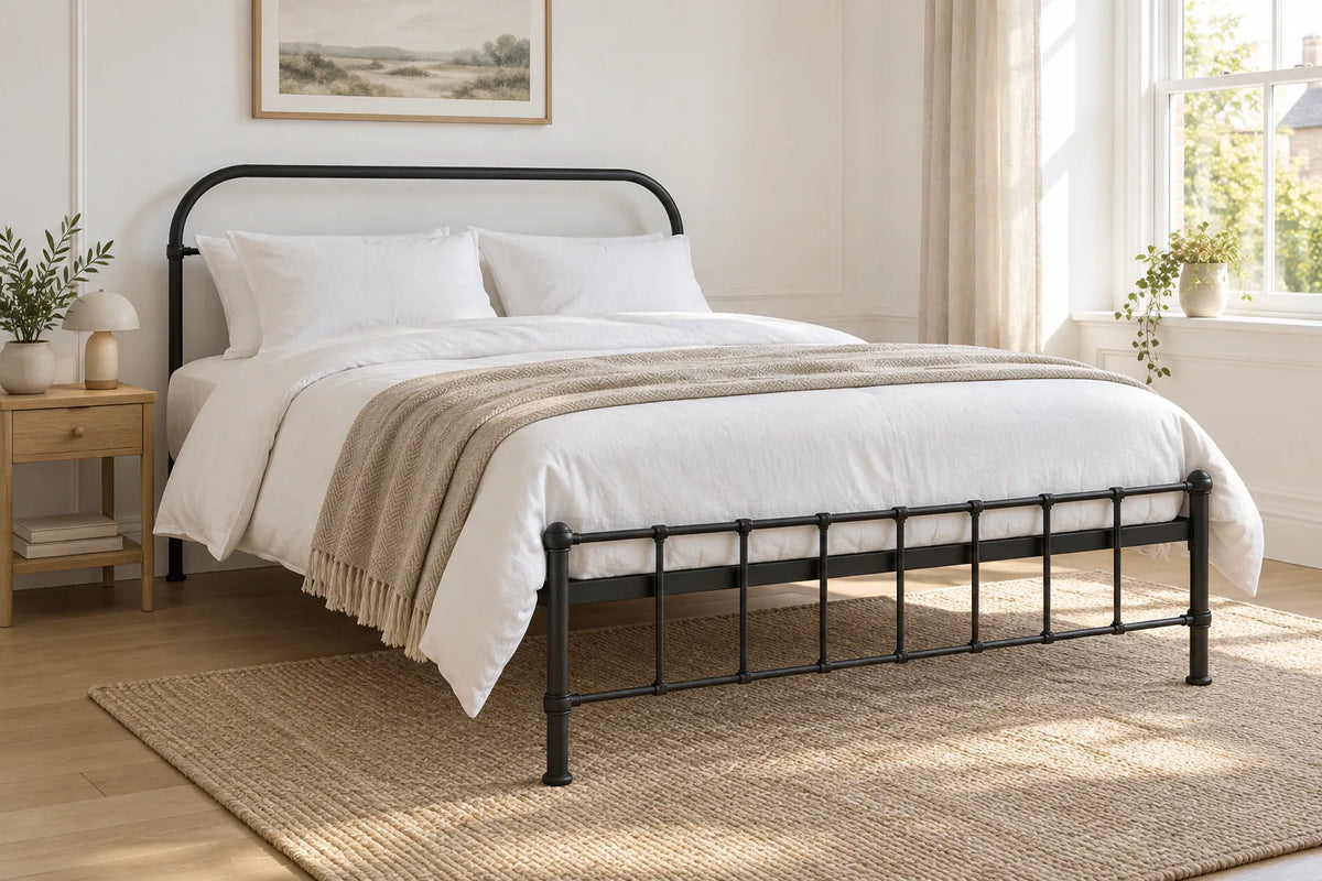 Peckham black iron bed frame, shown in a bright UK bedroom