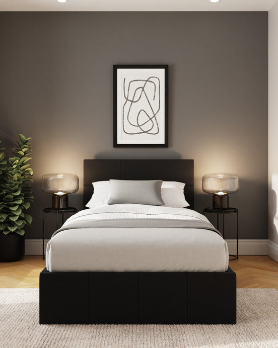 Stratford end lift ottoman bed, in black, in a bedroom with a taupe wall and one framed print