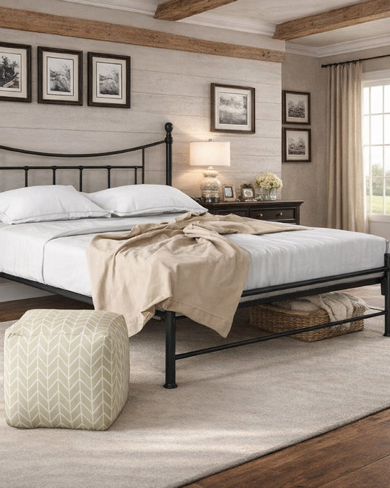 Walthamstow metal bed frame with a low foot end, in black, in a bedroom