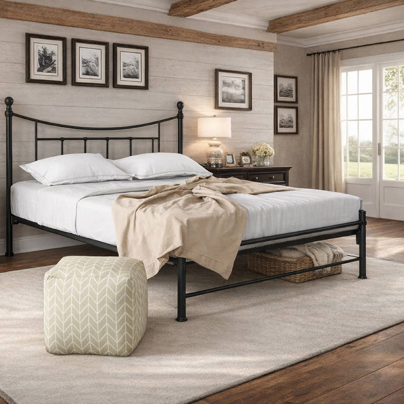 Walthamstow metal bed frame with a low foot end, in black, in a bedroom