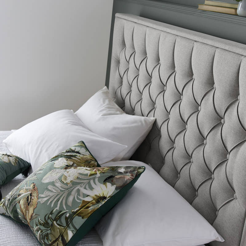 Wembley fabric ottoman bed in grey, close-up of the buttoned headboard