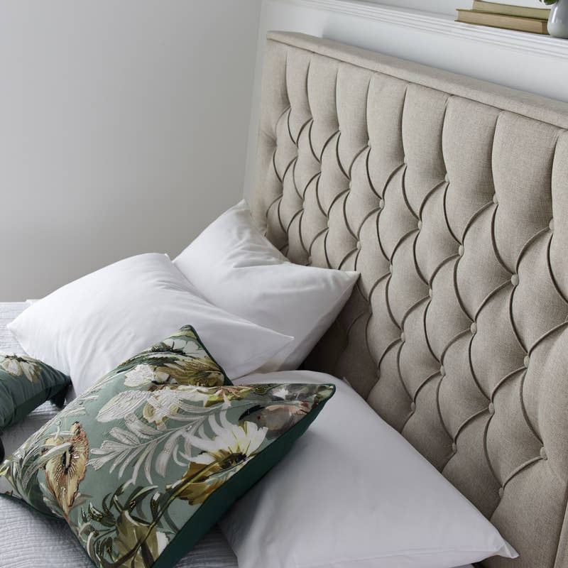 Wembley fabric ottoman bed in oatmeal, close-up of the buttoned headboard
