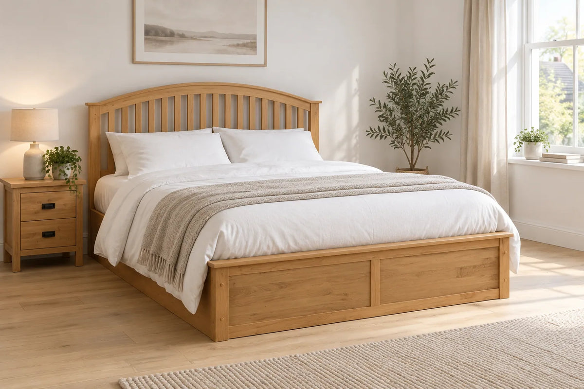 Windsor oak wooden ottoman bed with a panelled headboard, shown in a bright UK bedroom