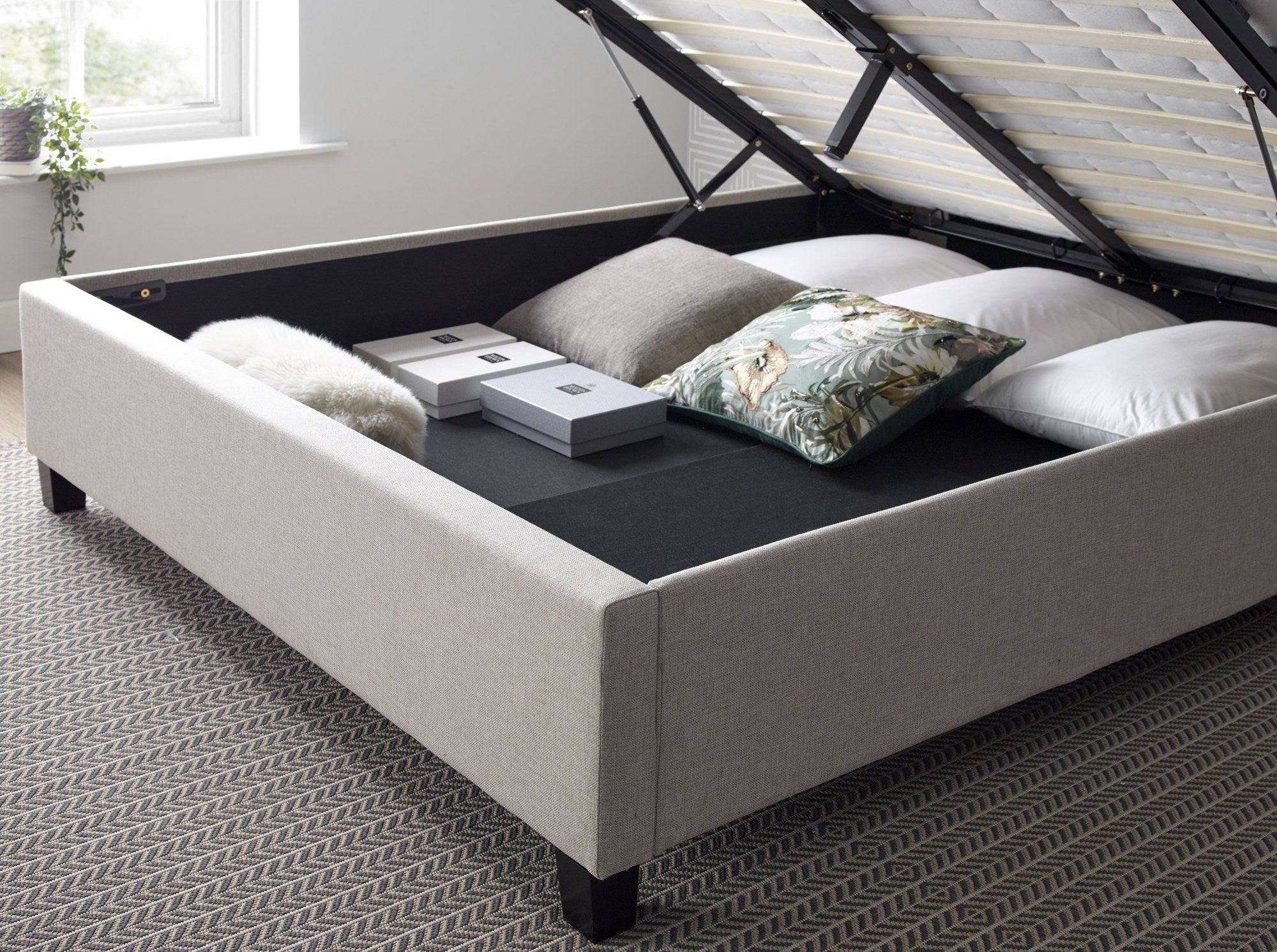 Tooting fabric ottoman bed in oatmeal, inside the fully boarded storage