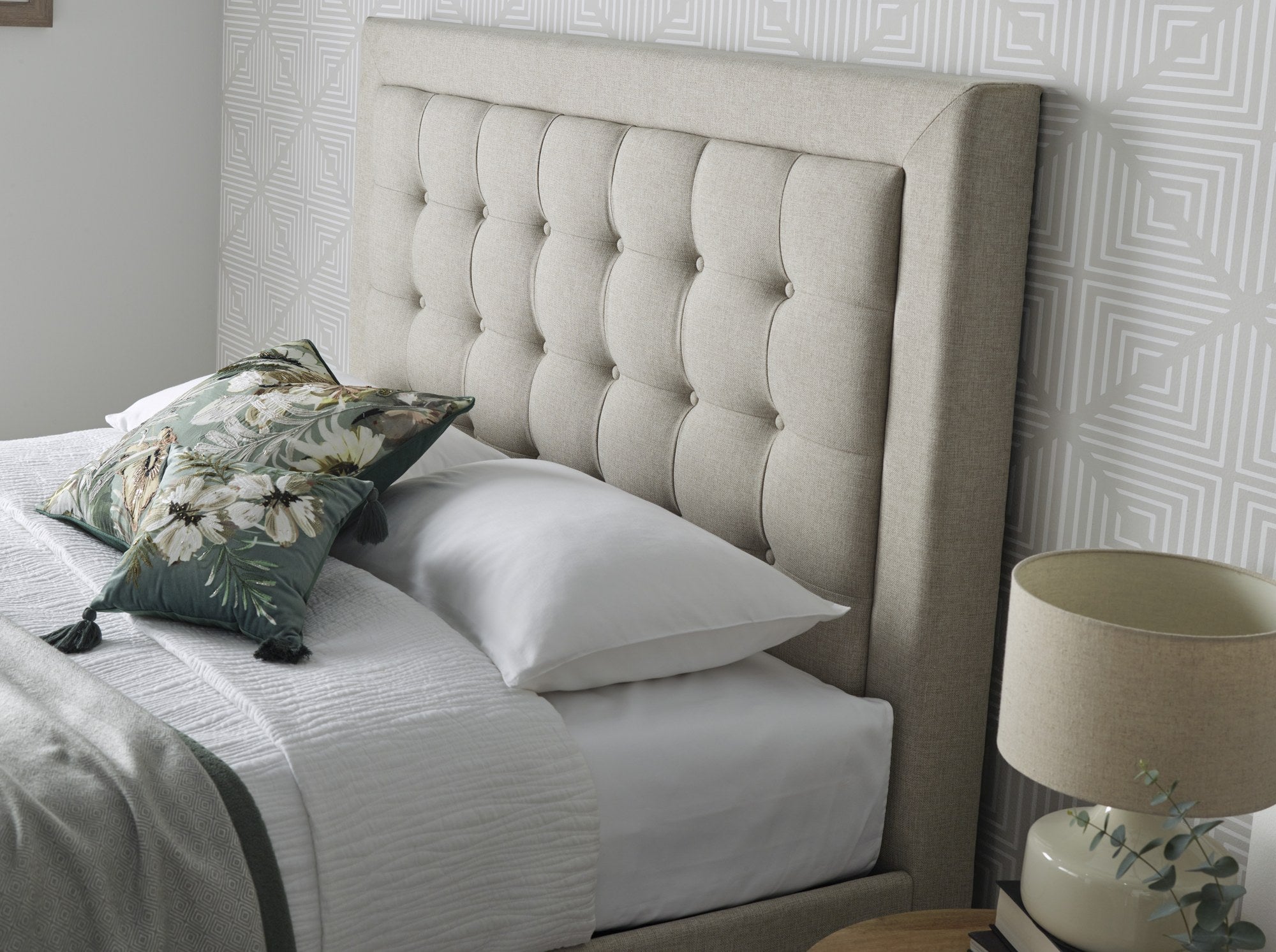 Tooting fabric ottoman bed in oatmeal, close-up of the buttoned headboard