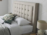 Tooting fabric ottoman bed in oatmeal, close-up of the buttoned headboard