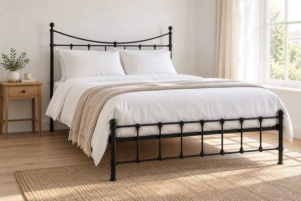 Brixton black iron bed frame, shown in a bright UK bedroom