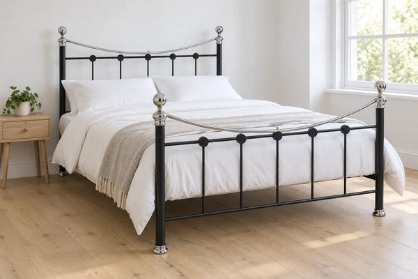 Brunel black steel metal bed frame, shown in a bright UK bedroom