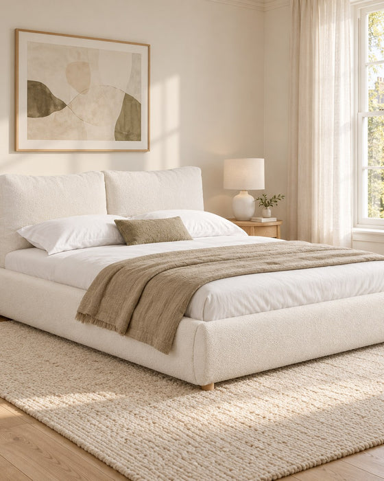 Primrose bouclé cloud bed in warm white, in a bright bedroom (AI-generated illustration of this frame; bedding for illustration, mattress not included)