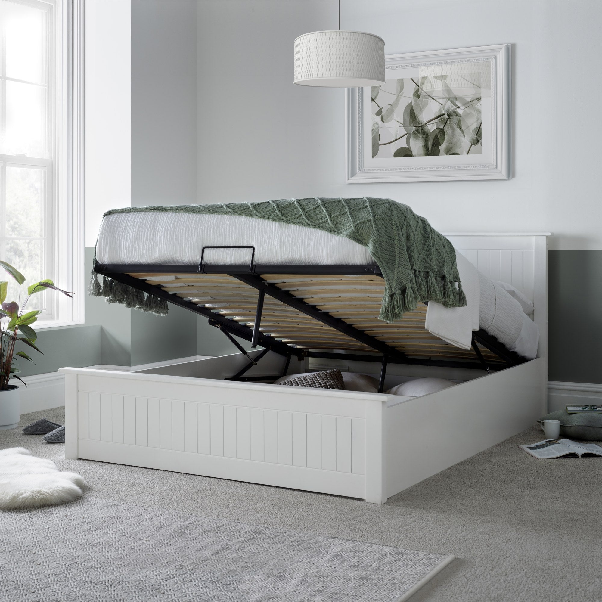 Acton wooden ottoman bed in white, with the gas lift storage open