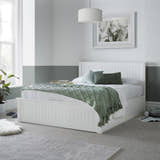 Acton wooden ottoman bed in white, closed, in a bedroom