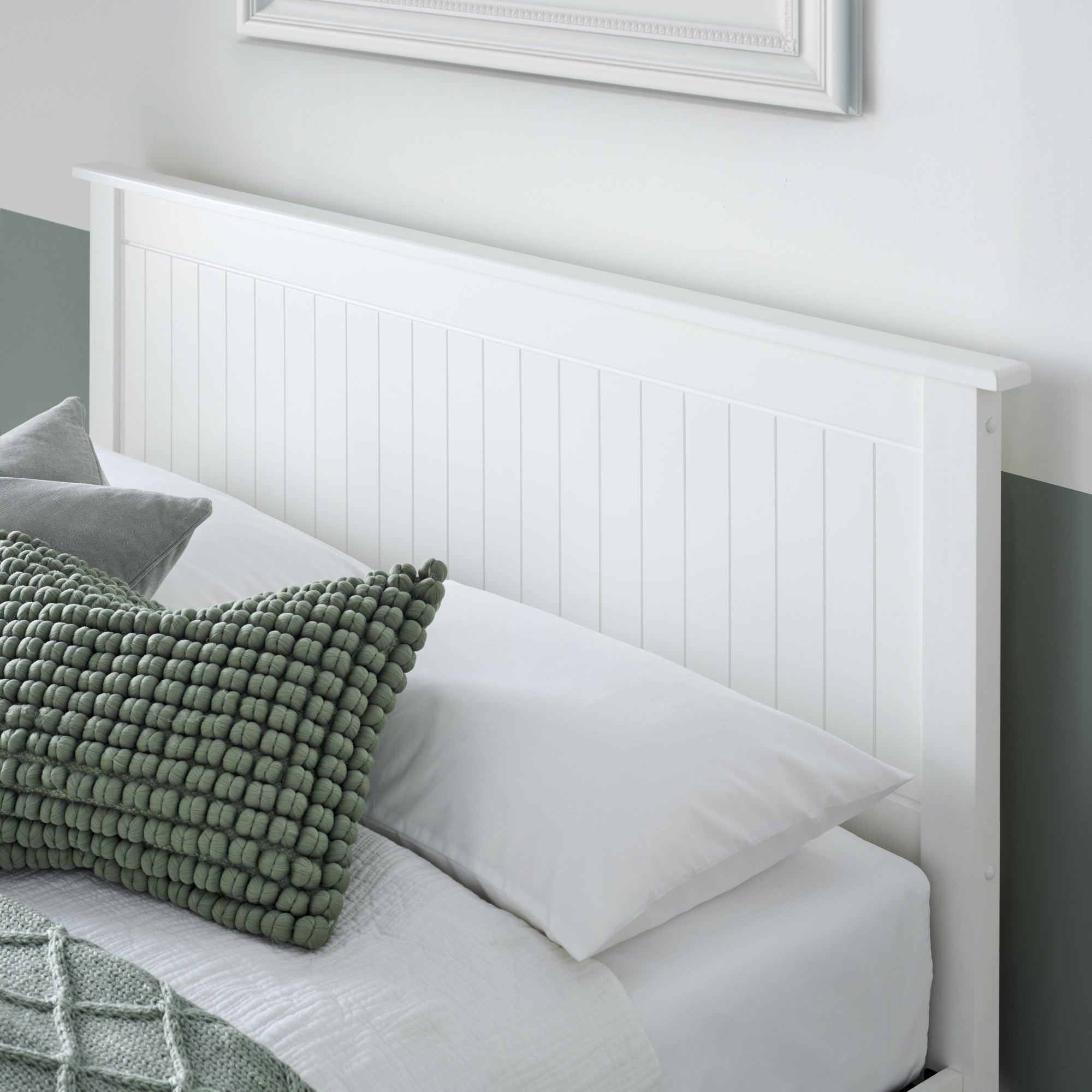 Acton wooden ottoman bed in white, close-up of the panelled headboard