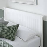 Acton wooden ottoman bed in white, close-up of the panelled headboard