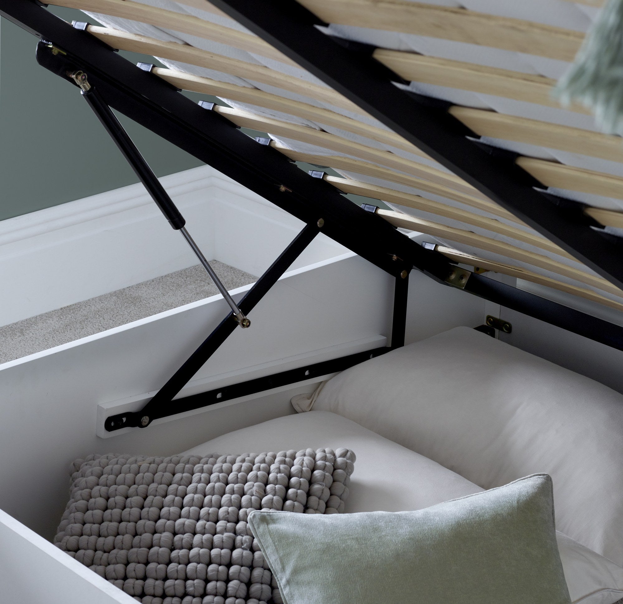 Acton wooden ottoman bed in white, the gas struts and storage