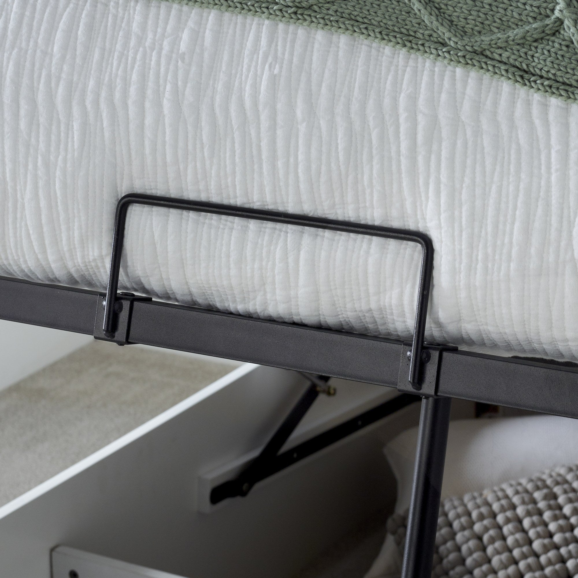 Acton wooden ottoman bed in white, detail of the lift handle