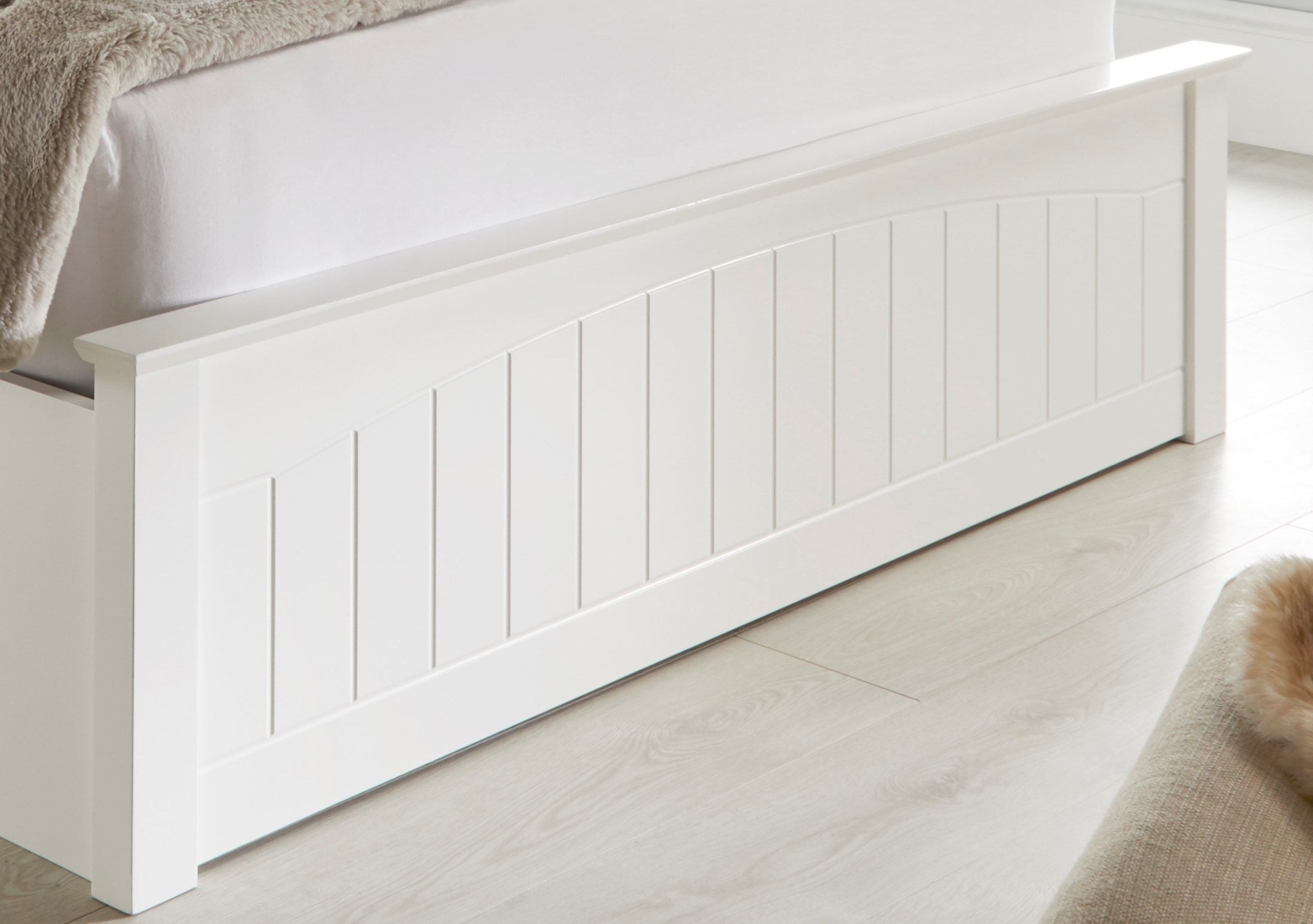 Barnet wooden ottoman bed in white, the panelled foot end