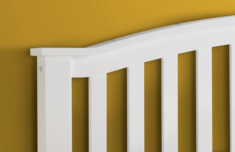 Barnet wooden ottoman bed in white, close-up of the curved headboard