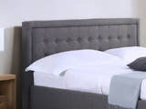 Hammersmith grey fabric ottoman bed with a buttoned headboard, close-up of the buttoned headboard