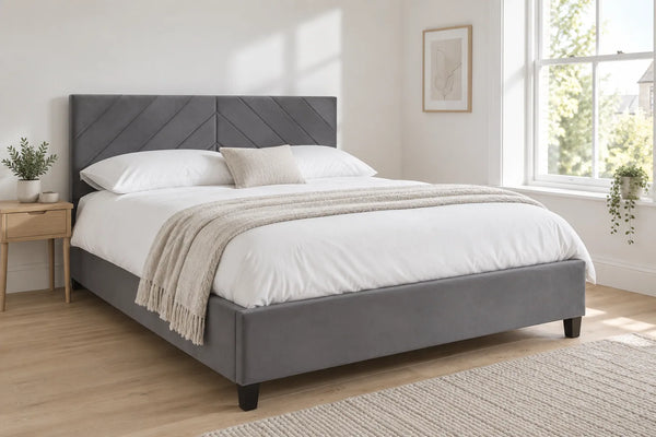 Hoxton grey velvet ottoman bed with a chevron headboard, shown in a bright UK bedroom