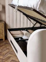 Alana TV bed: the gas lift base raised from the side to show the storage, close up
