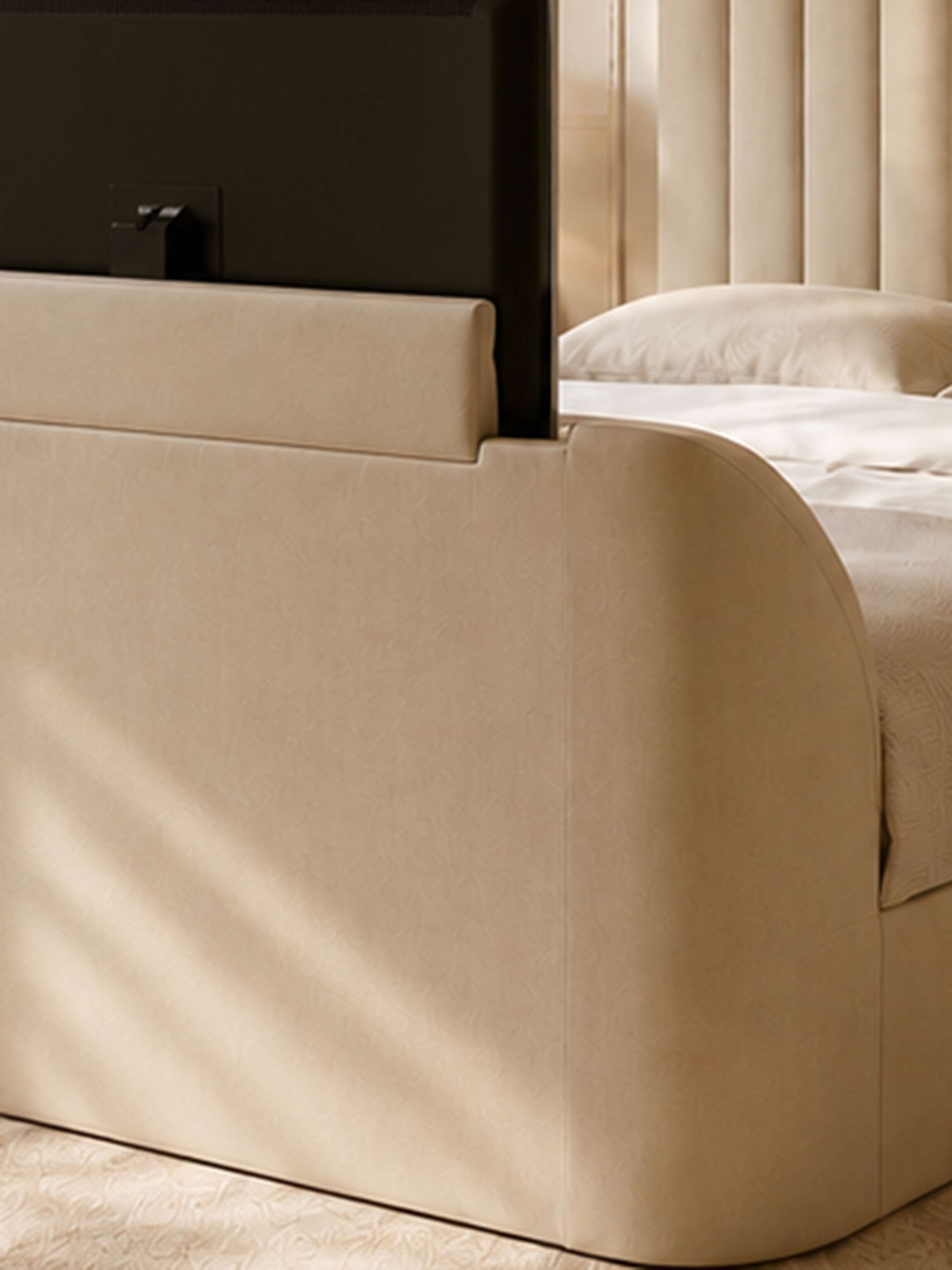 Alana TV bed: the TV lift rising from the curved footboard, close up
