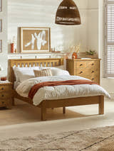 Julian Bowen Amsterdam low footend bed in light oak, in a bedroom with an oak chest