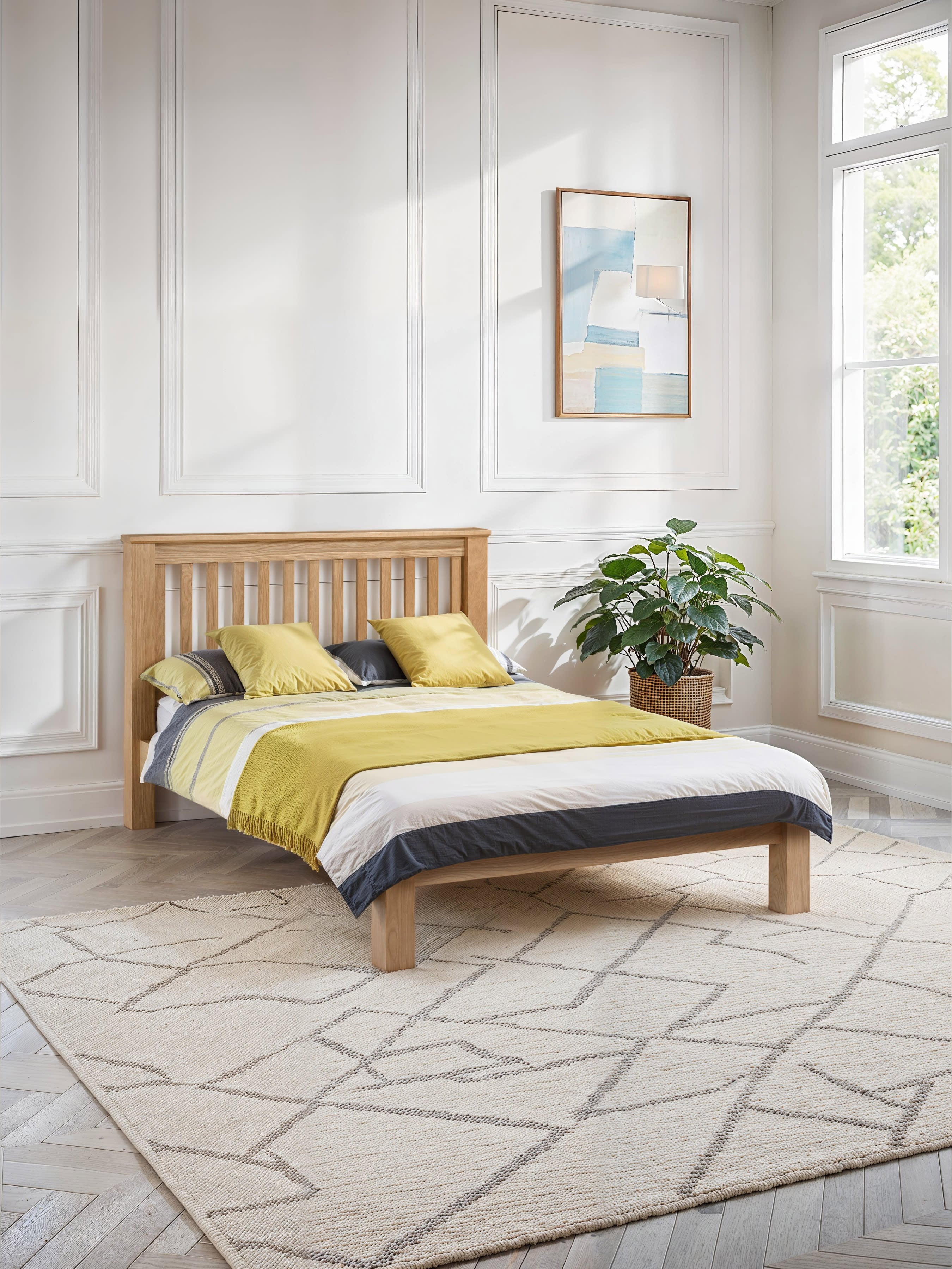 Julian Bowen Amsterdam oak bed with a slatted headboard in a panelled bedroom