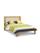 Julian Bowen Amsterdam low footend oak bed made up, on a white background