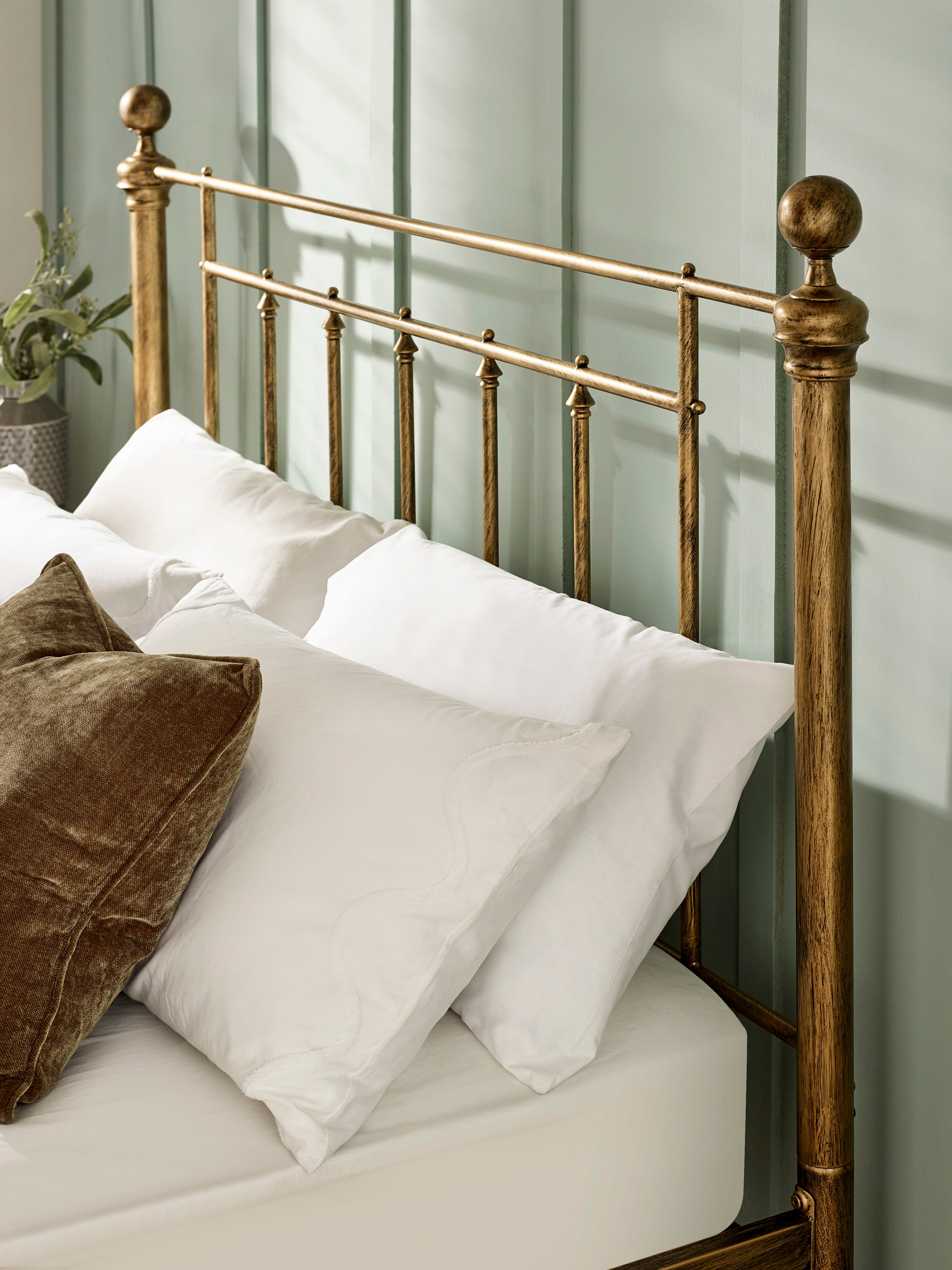 Aurelia bed: the brass effect headboard bars and round finial, with pillows