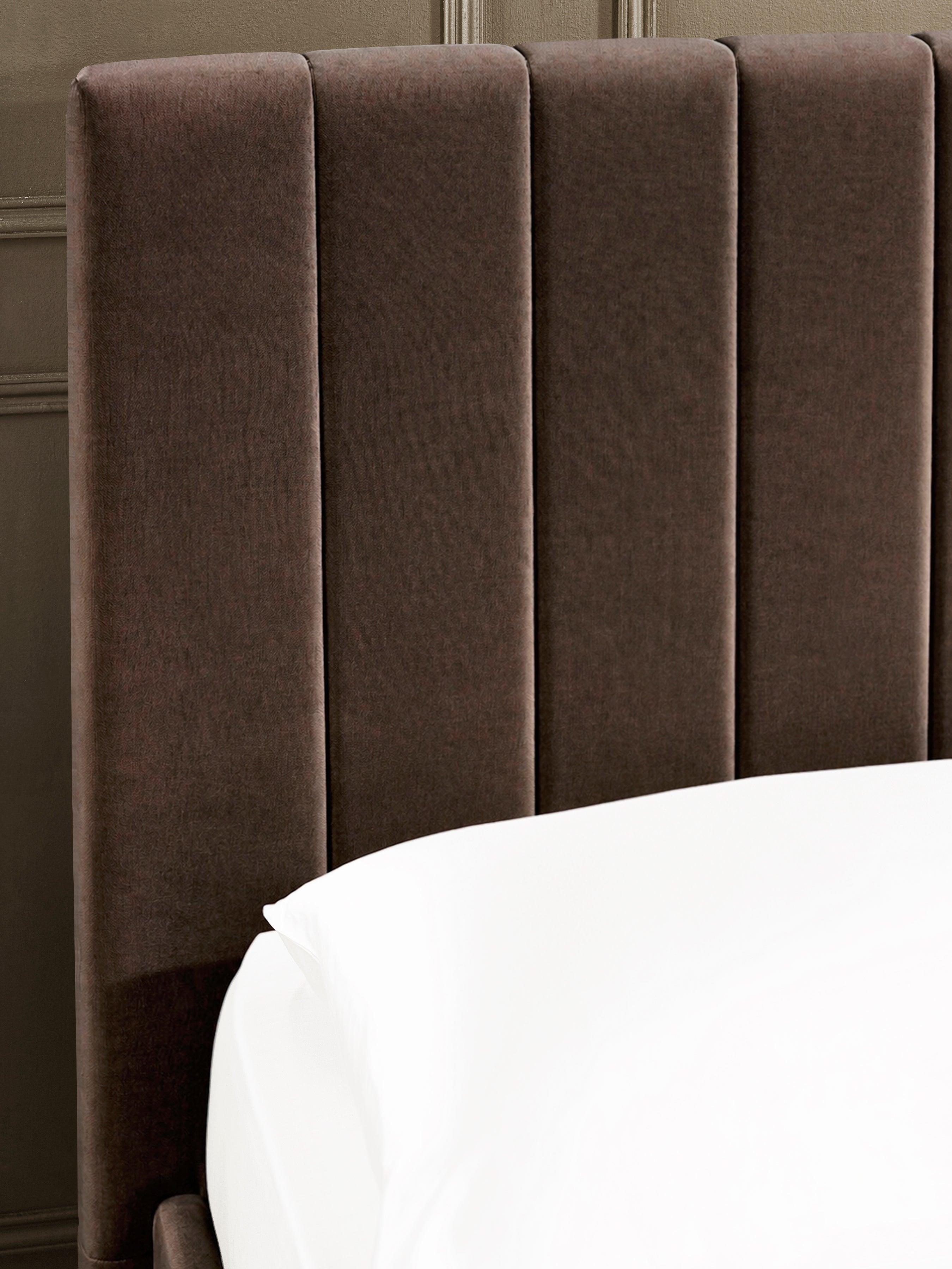 Aylen bed: chocolate velvet headboard padded in vertical channels, close up